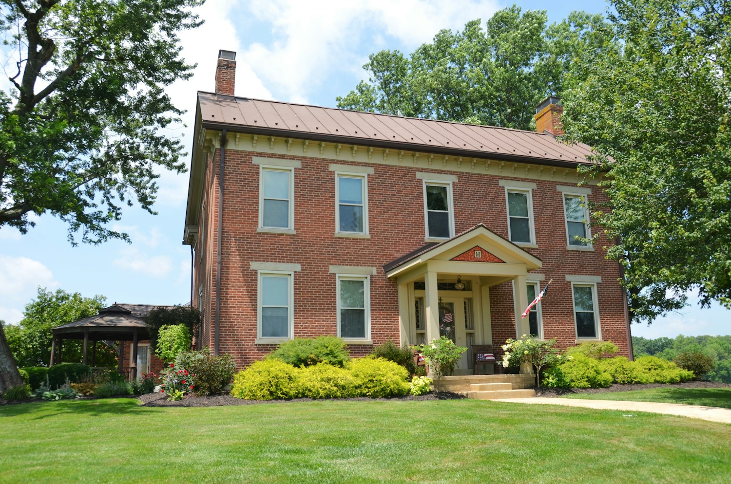 A traditional brick home with a welcoming covered porch